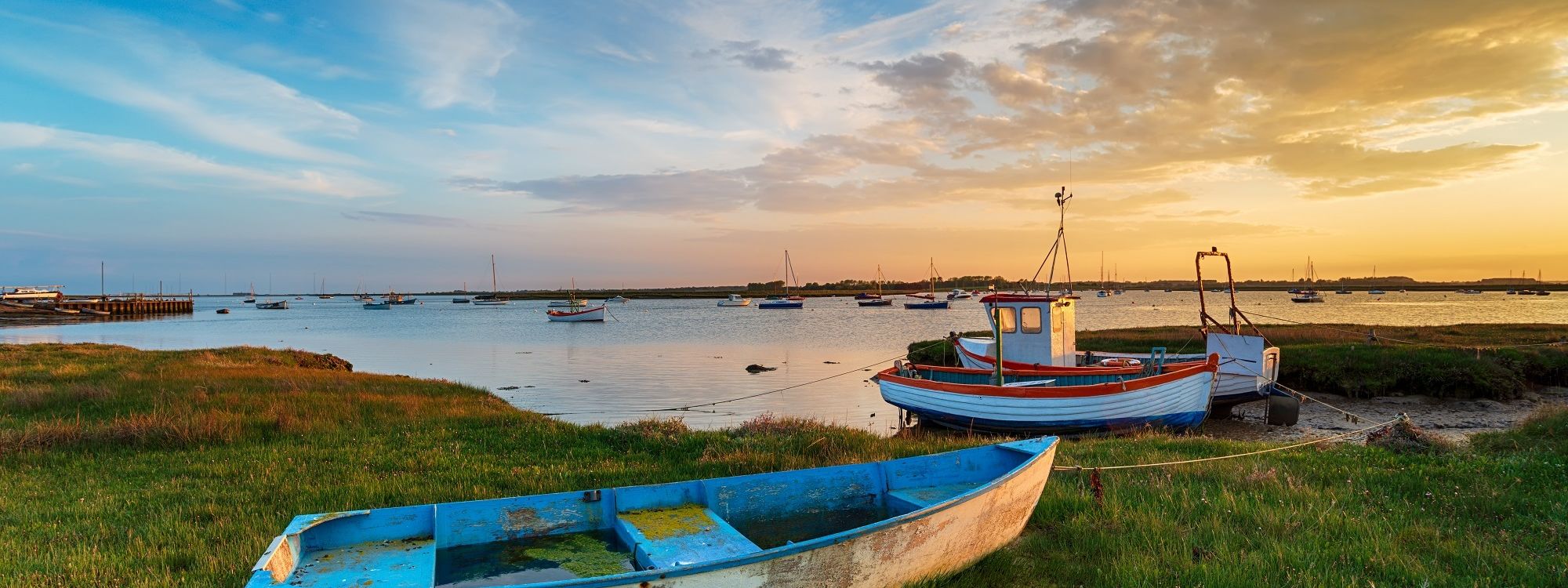 Beautiful sunset over old fishing boats in suffolk